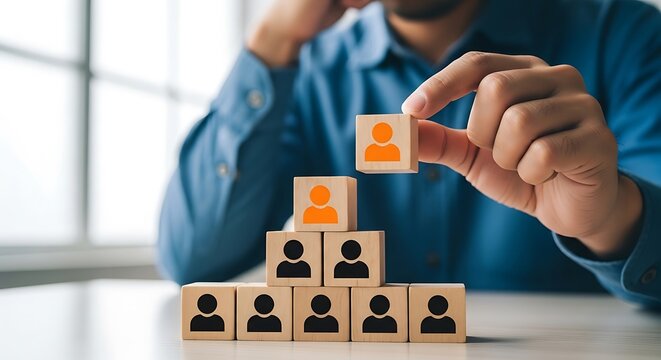 Businessman adding a new member to a growing team with wooden blocks