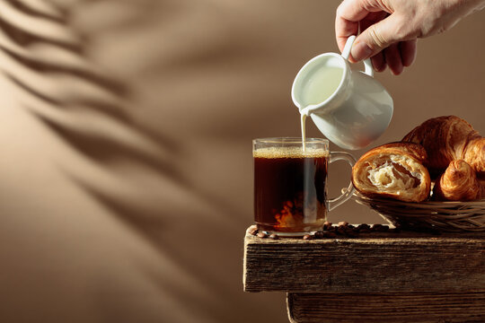Coffee latte with croissants on an old wooden table.