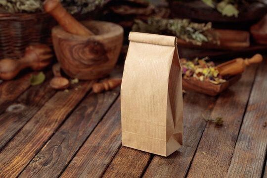 Tall brown paper bag on an old wooden table.