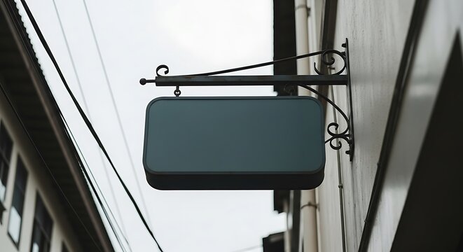 Mockup Logo Mockup Dark teal rectangular sign hanging from ornate metal bracket on building exterior blue