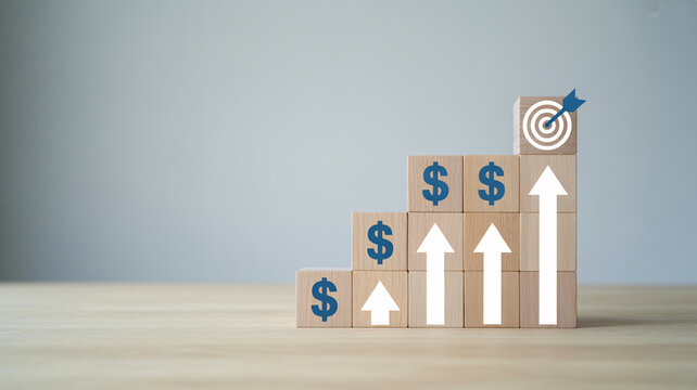 A stack of wooden blocks with dollar signs and arrows pointing upwards, symbolizing financial growth and success.