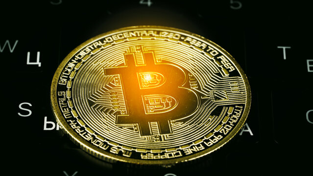 Golden Bitcoin coin gleams under spotlight