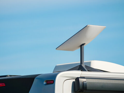 Awning on side of caravan and Starlink terminal on roof