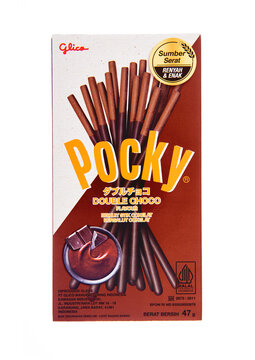 LONDON, UK - DECEMBER 18, 2024: Pocky original biscuit sticks coated with dark chocolate double choco on white background.Invented by Yoshiaki Koma