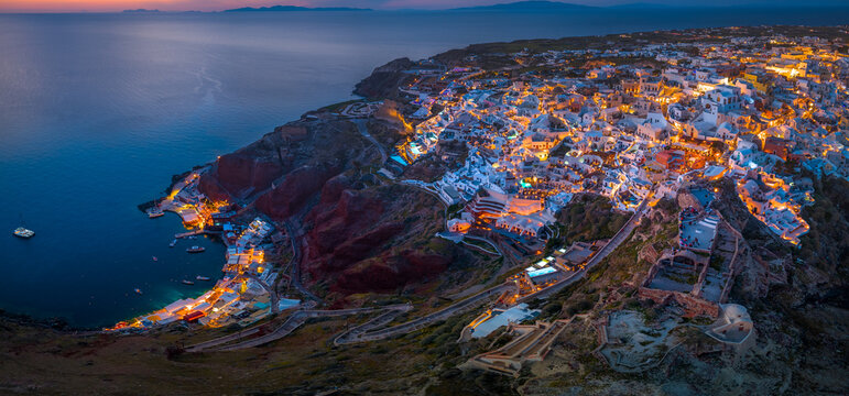 Aerial view of Oia town and caldera on Santorini island ay night, Greece. 