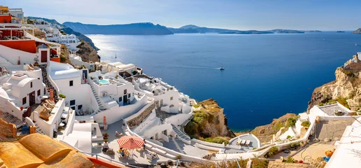 Fototapeten Santorini Oia town on Santorini island, Greece. Traditional and famous houses and churches with blue domes over the Caldera, Aegean sea  © gatsi