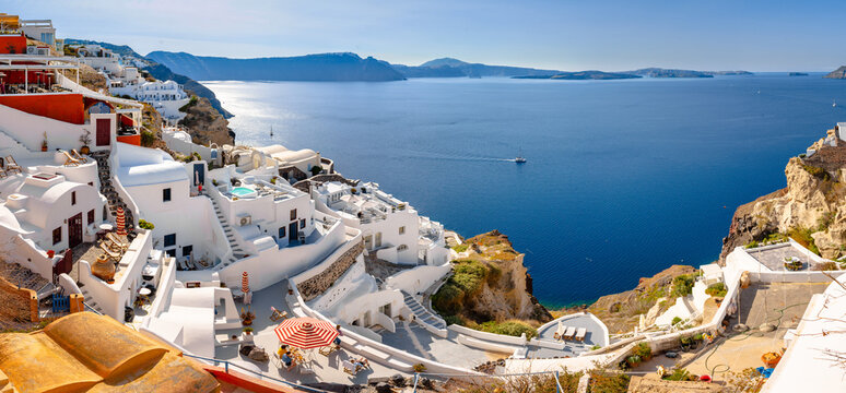 Oia town on Santorini island, Greece. Traditional and famous houses and churches with blue domes over the Caldera, Aegean sea