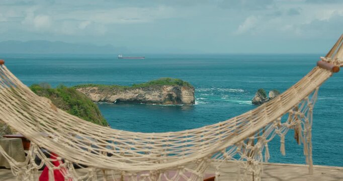 Empty Rope Hammock Hanging Between Trees At Scenic Overlook Of Bali Sea Coast Nusa Penida Indonesia