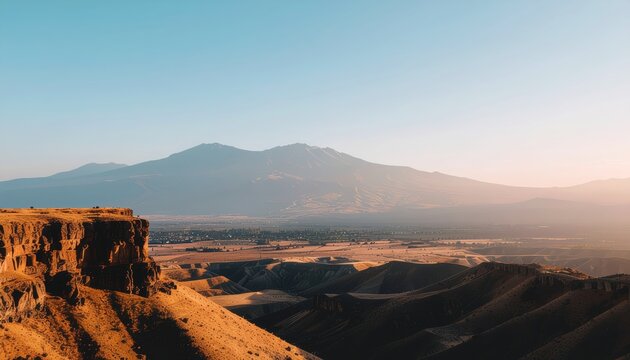 Spectacular vista of arid landscape with majestic mountains beneath clear sky