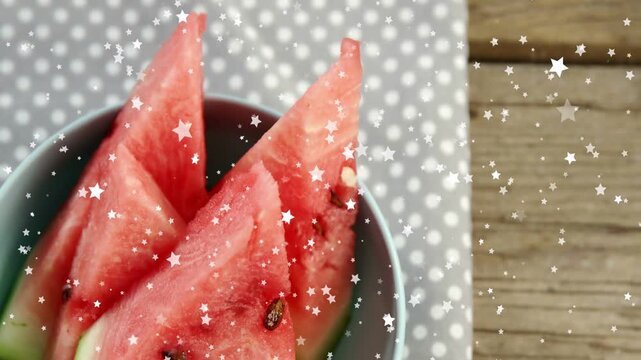 Round bowl of watermelon wedges moving as camera panning out, stars drifting, for food marketing