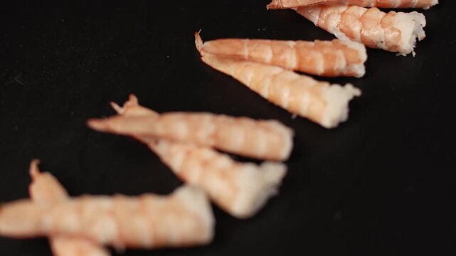 Delicious ebi nigiri sushi with fresh shrimp and rice perfectly arranged on a dark background, representing traditional japanese cuisine and gourmet seafood preparation
