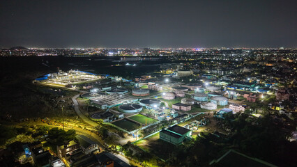 Fototapeta premium Sewage treatment plant illuminated at night with industrial infrastructure