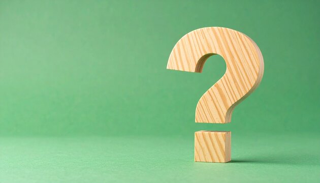 Wooden question mark upright smooth texture green background