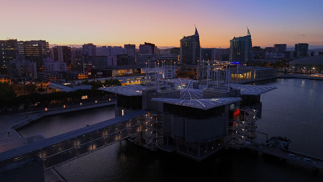 Lisbon, Portugal - April 14, 2026: Aerial view of Oceanario de Lisboa and Parque das Nacoes waterfront at dusk