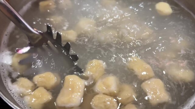 Potato gnocchi boiling in pot of water