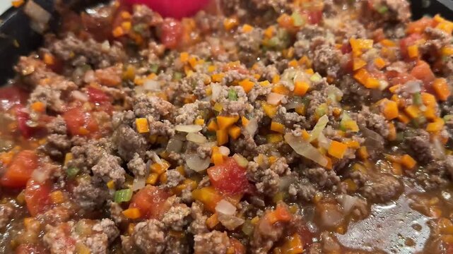Cooking italian bolognese sauce in a pan