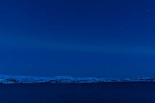 Northern lights with snowcapped mountains view. Finnmark, Norway