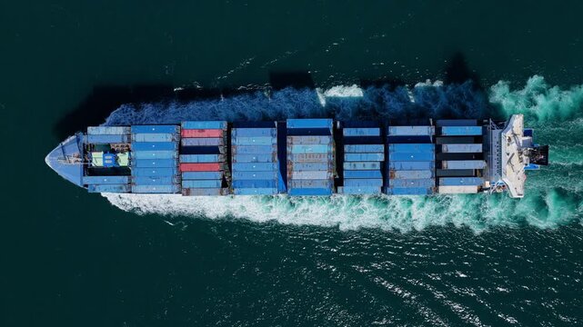 Freight container loaded on cargo vessel. Top view cargo ship entering harbor. Cargo business. Container ship. Shipping logistics. Commercial shipping. Cargo ship in sea, aerial view