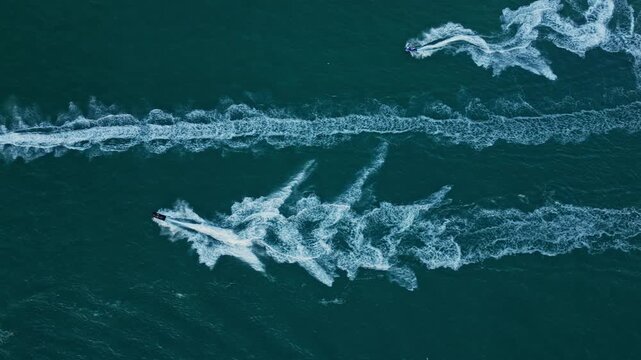 Water sport activity in summer. Sea beach lifestyle. Beach life concept. Vacation on summer. Aerial view at vacation. Jet ski in 4k motion. Summer vacation activity
