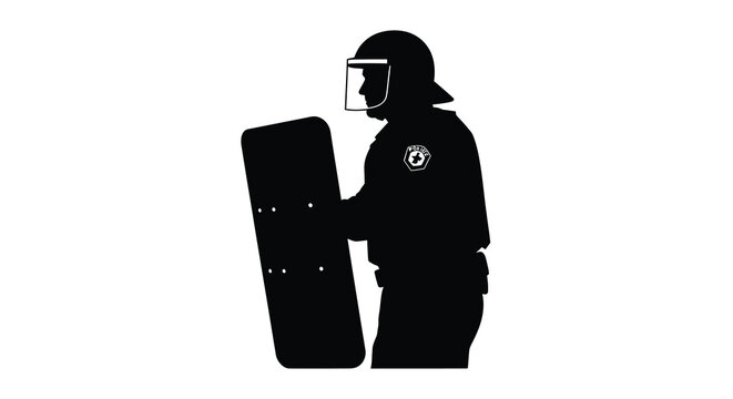 Silhouette of a riot police officer holding a shield and wearing a helmet