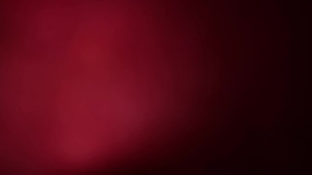 Una toma de cerca de un fondo abstracto de color rojo o anaranjado con negro un degradado ligero desenfocado en movimiento