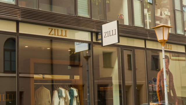 Zilli Storefront with large windows and reflective displays in a lively city