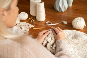 Woman's hands knitting wool yarn pattern. Close up picture. © Raisa Kanareva