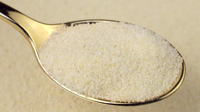 Semolina in the spoon with background circle rotation close up