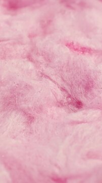 Light pink sweet fluffy cotton candy texture circle rotation close up, vertical video
