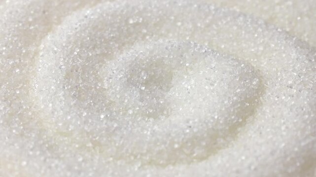White sugar grains texture circle rotation close up