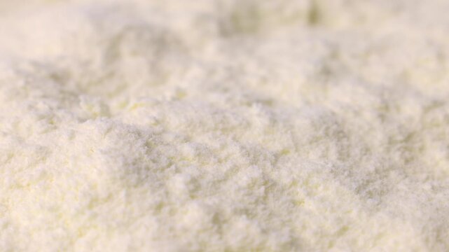 White powdered milk or baby formula texture circle rotation close up