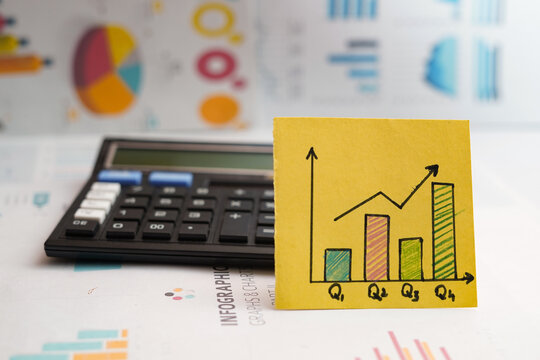               Quarterly business growth overview concept with Q1 Q2 Q3 Q4 charts calculator and infographic data analysis copy space 