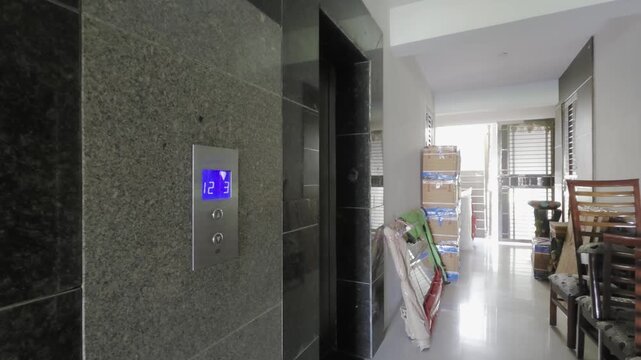 Gurgaon, Delhi, India - 7th Apr 2026: Panning shot from lift to corridor filled with packing boxes, cartons, wrapped furniture showing the shifting, relocation, coming to new house city