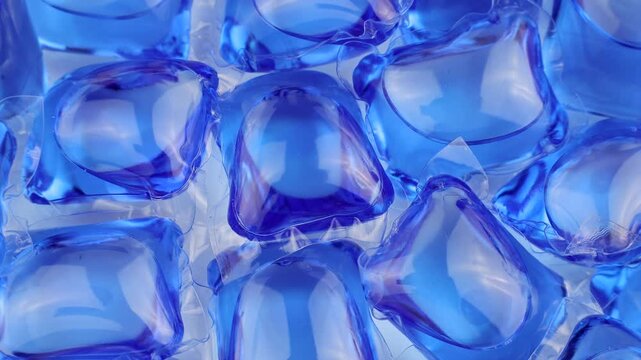 Blue laundry detergent pods or liquitabs for washing machine circle rotation close up