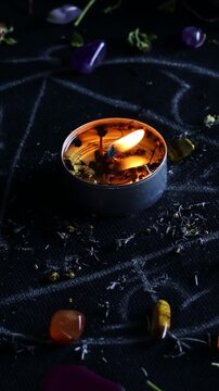 Vertical video, Black magic ritual background with magical altar, candles, crystals and herbs. Sorcerer rite of witchcraft and occultism. Halloween occult, esoteric and divination concept.