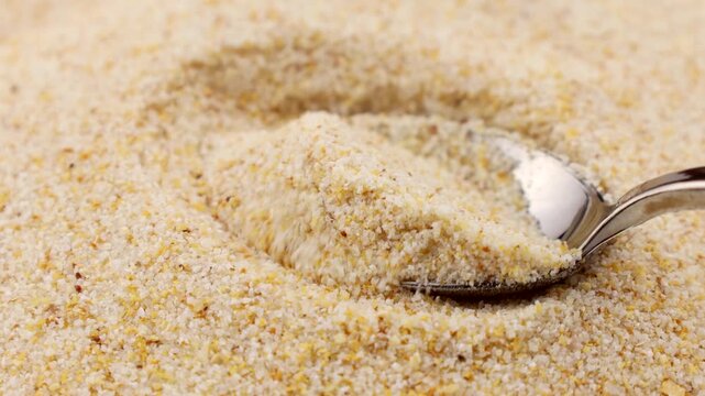 Dried granulated garlic taking with a spoon close up