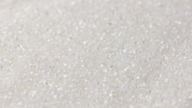 White sugar grains texture circle rotation close up