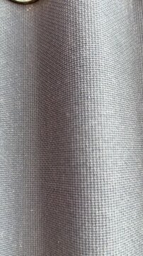 Close-up ondulin roofing tile texture showing corrugated gray waves with fine fibrous grain, subtle light and shadow, suited.