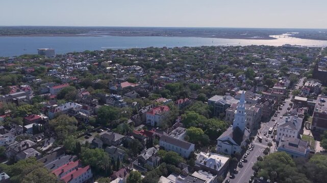Aerial-Flying over old historic residential homes and church toward the Ashley River in the lower Charleston, South Carolina peninsula