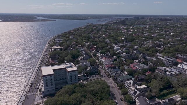CHARLESTON, SOUTH CAROLINA, USA - APRIL 10, 2026: Aerial-Flying over the Low Battery seawall running along Murray Blvd and  Ashley River