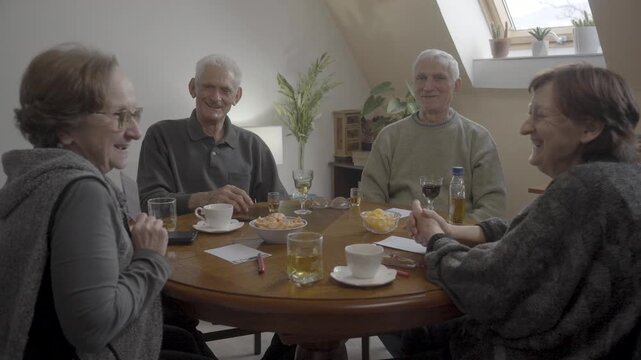 Senior friends playing guess game at home
