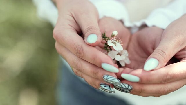 Sustainable Future: Young Child and Mother Hands Caring for Spring Nature