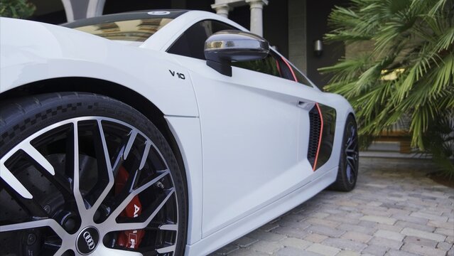 Maspalomas, Las Palmas, Canary Islands, Spain - April 13, 2024 - White Audi R8 V10 luxury supercar parked in a residential setting, showcasing design, wealth, and performance