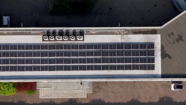 Solar Panel Array on Rooftop: An elevated perspective captures a modern rooftop adorned with rows of solar panels, capturing clean energy. 