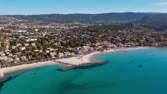 La Ciotat bay shoreline with public beach facilities, aerial view. Cote d Azur coastal town in France