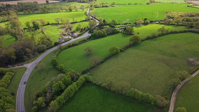 Aerial drone footage of the lush green countryside in Hampshire, England, featuring rolling fields, farmland, and rural landscapes