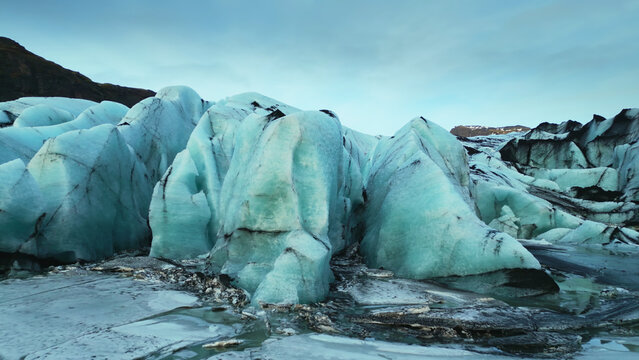 Drone shot of vatnajokull ice cap floating on nordic lake, forming beautiful arctic landscape. Icelandic scenery with huge glacier mapp and lagoon with frosty icebergs. Slow motion.