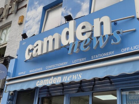 London UK 05.07.2025 Camden news storefront sign on blue facade showing local convenience shop offering magazines confectionery lottery and stationery in urban street retail environment