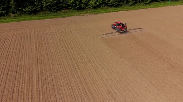 Tractor Plowing a Field: Capturing the image of a bright red tractor meticulously plowing a vast field, showcasing the power of agriculture and the promise of a bountiful harvest.