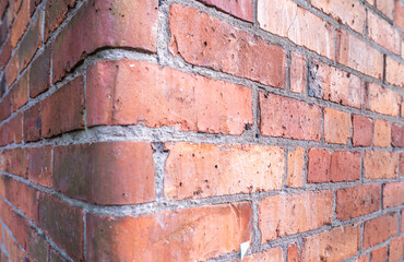 Obraz premium Close-Up of Weathered Red Brick Wall Corner Texture